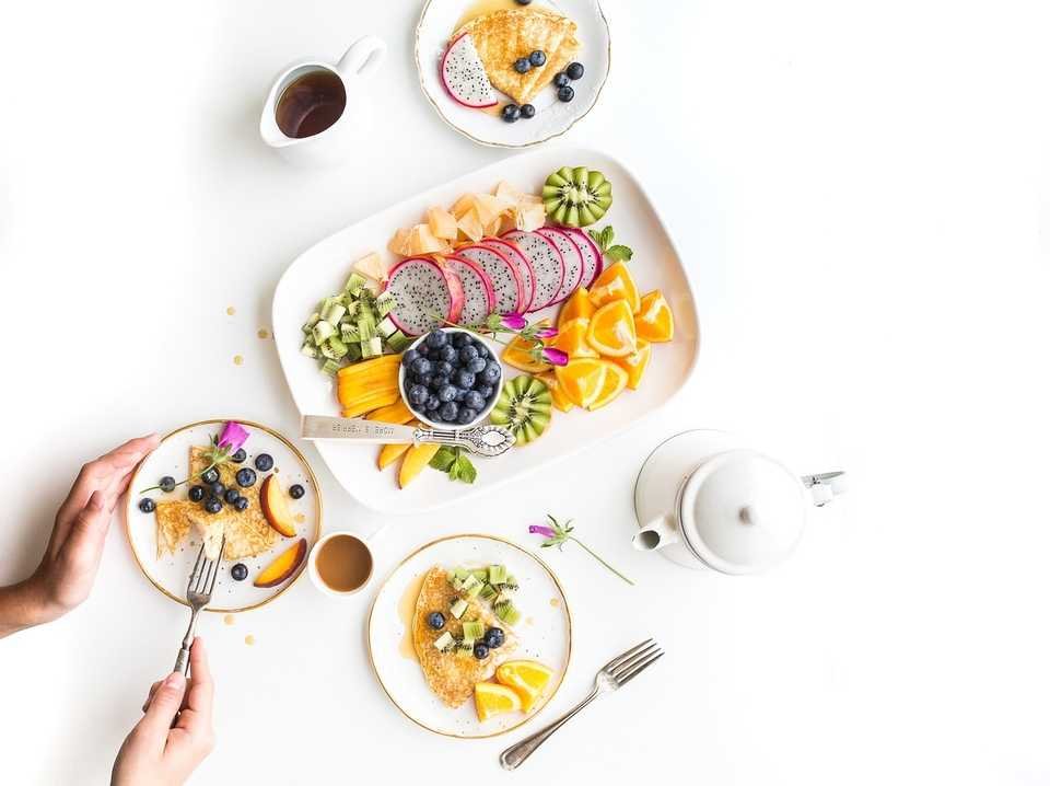 a plate of nutritional fruit and vegetables on a white table