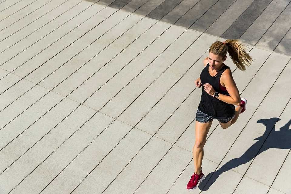 a woman running on a concrete surface - showing Physical wellness